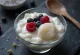Warabi mochi cubes served over tofu pudding with berries