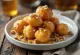 Golden fried Zeppole Italian doughnuts topped with honey and walnuts